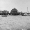 <p>Passenger Dock with boathouse (left) and baggage room (right), which were removed in 1938. The Hamilton, an Army tugboat, is moored to the pier. View southeast, ca. 1893.</p>